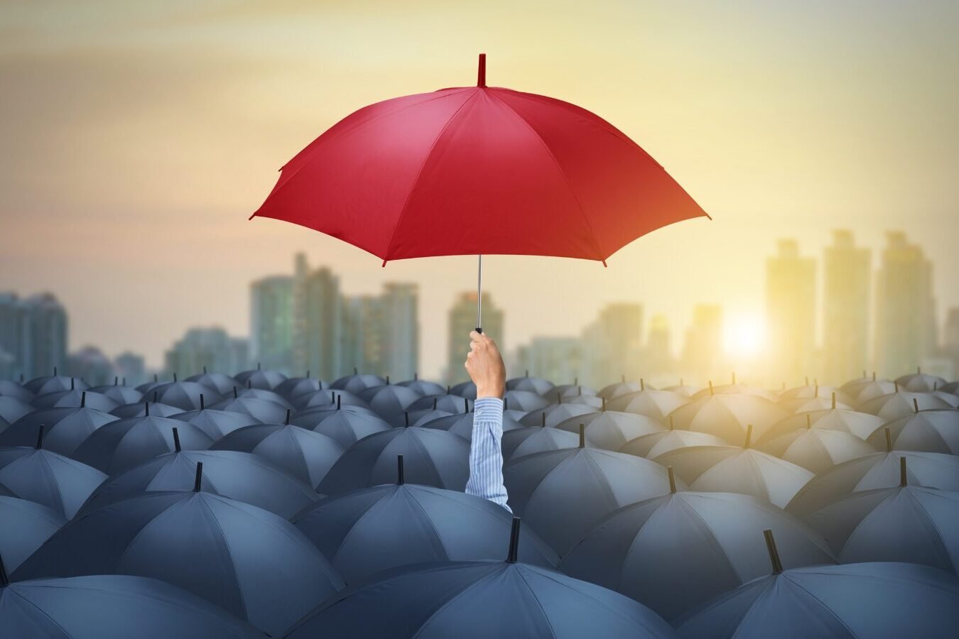 Red umbrella in a crowd of black umbrellas edited